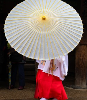 Shrine maiden with umbrella at Kasuga-Taisha-Shrine, Nara, Japan.