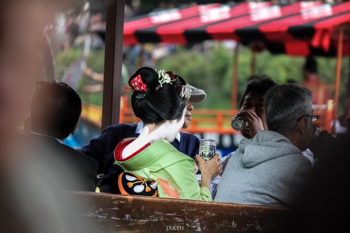 Maiko drinking beer on a boat